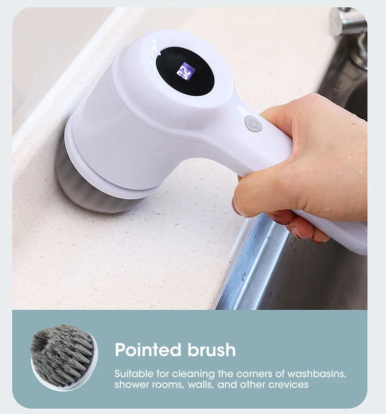 Handheld cleaning brush with pointed brush attachment held by a hand over a sink.